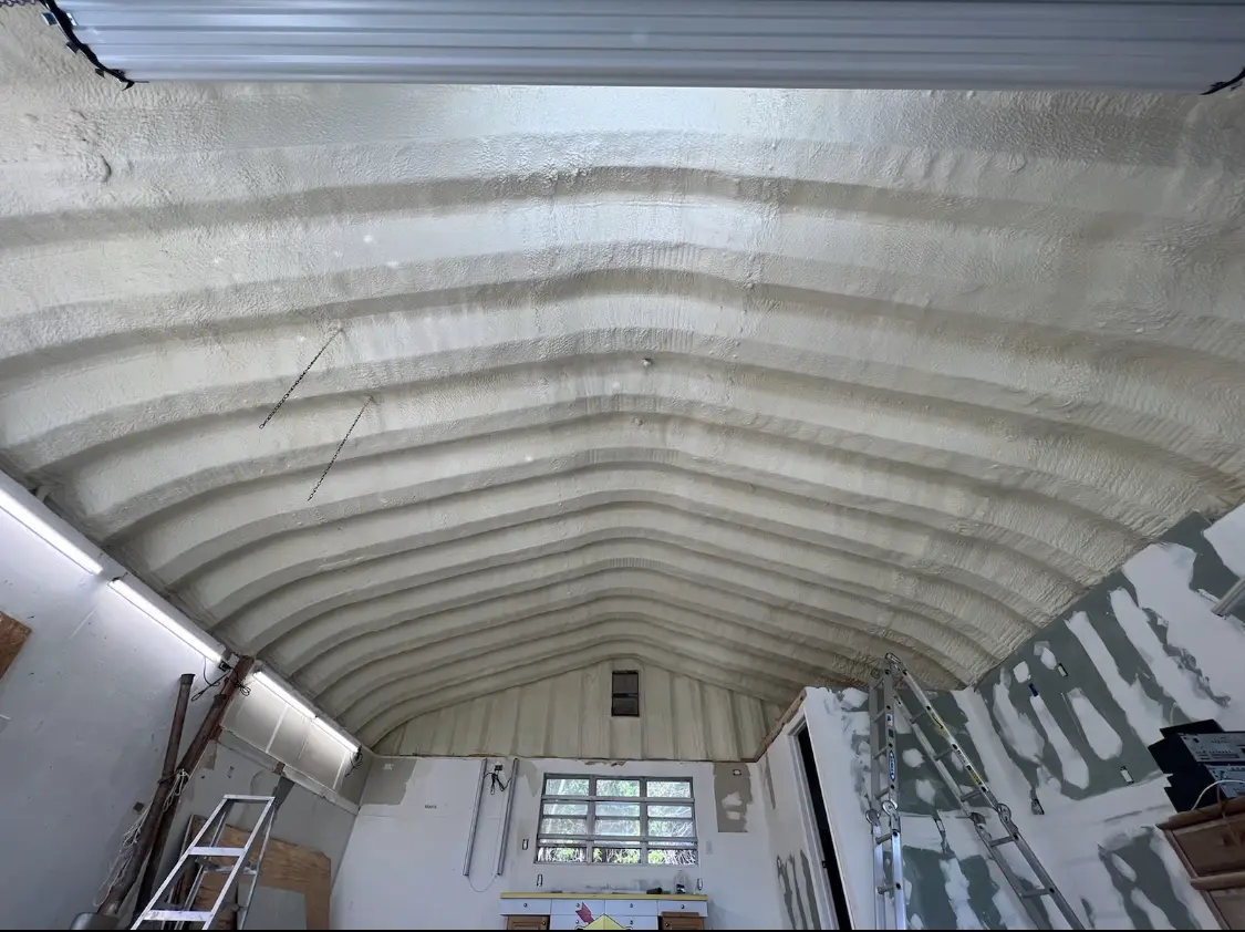 Spray polyurethane foam applied to the underside of a metal roof deck in Smithfield